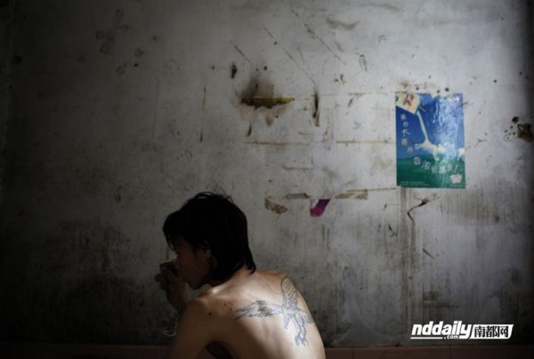 Chinese drug addict Wu Guilin inside a filthy and run down room that is his home.