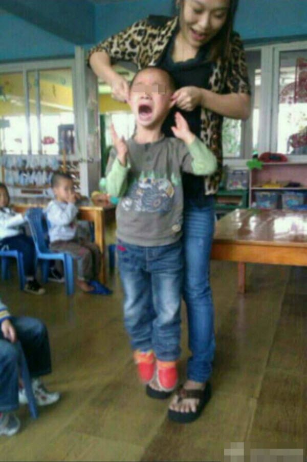 chinese-kindergarten-teacher-yan-yanhong-lifting-boy-off-ground-by-the-ears.jpg